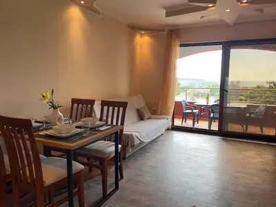 a living room with a table and a couch at Apartman u Bečićima in Budva
