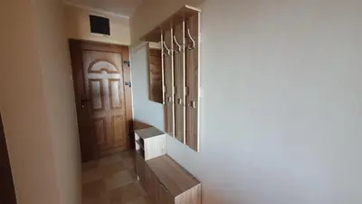 a hallway with a wooden door and a stairway at Apartman u Bečićima in Budva