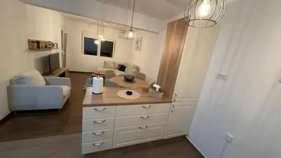 a living room with a couch and a dresser at Galeb Family Apartments in Budva