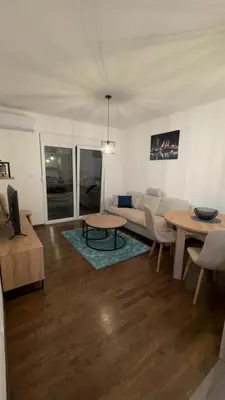 a living room with a couch and a table at Galeb Family Apartments in Budva
