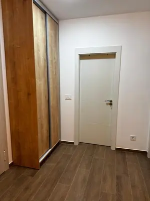 an empty room with a door and a hallway at Galeb Family Apartments in Budva