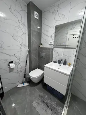 a bathroom with a white toilet and a sink at Galeb Family Apartments in Budva