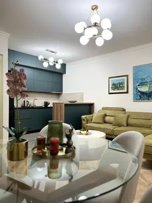 a living room with a glass table and chairs at Stay Point Jerry - Podgorica City Apartment in Podgorica