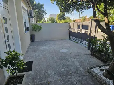 a parking lot next to a white fence at Stay Point Jerry - Podgorica City Apartment in Podgorica