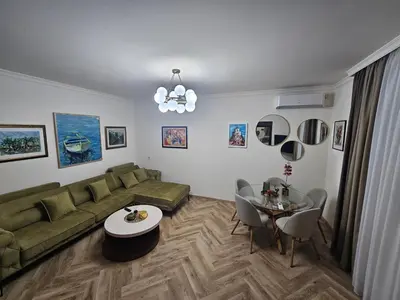 a living room with a couch and a table at Stay Point Jerry - Podgorica City Apartment in Podgorica