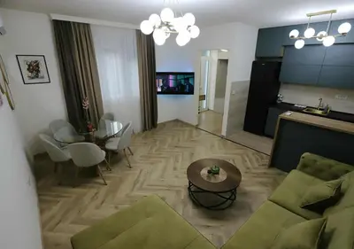 a living room with a couch and a table at Stay Point Jerry - Podgorica City Apartment in Podgorica