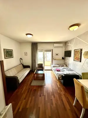 a living room with a couch and a table at Stex Elite City Kvart in Podgorica