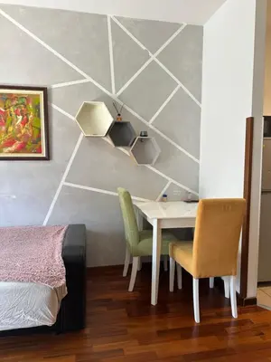 a bedroom with a table and two chairs and a bed at Stex Elite City Kvart in Podgorica