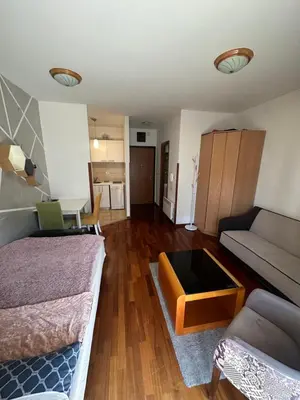 a living room with a bed and a couch at Stex Elite City Kvart in Podgorica