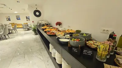 a buffet line with many plates of food on it at Azure Coast Residence Rafailovici -Seaside Living Apartments in Becici