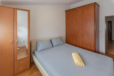 a bedroom with a bed with a wooden cabinet at Parkview Bar in Bar