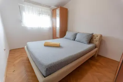 a bed in a small room with a mirror at Parkview Bar in Bar