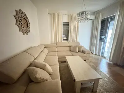 a living room with a couch and a table at Apartment Central Budva in Budva
