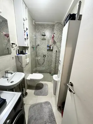 a bathroom with a shower and a toilet and a sink at Apartment Central Budva in Budva