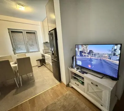 a living room with a large flat screen tv at Apartment Central Budva in Budva