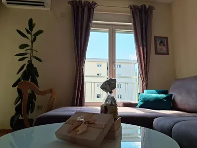 a living room with a box on a glass table at The Lilac Lounge in Podgorica