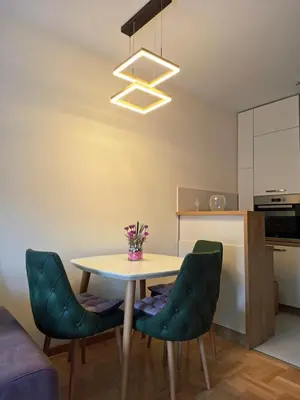 a dining room with a table and two chairs at The Lilac Lounge in Podgorica