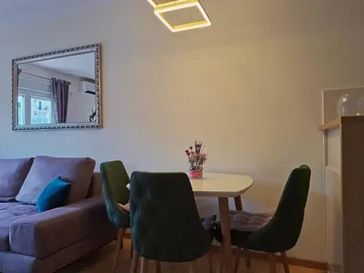 a living room with a table and a couch at The Lilac Lounge in Podgorica
