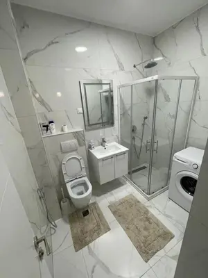 a bathroom with a toilet and a shower and a sink at Apartman Celuga in Bar