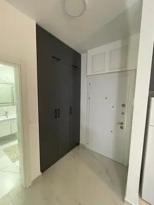 a white room with a closet and a door at Apartman Celuga in Bar