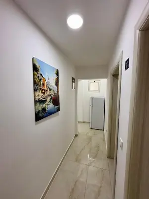 a hallway with white walls and a painting on the wall at Guest house, Small beach in Ulcinj