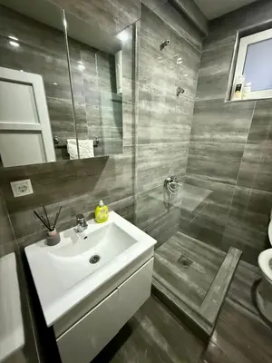 a bathroom with a sink and a shower at Guest house, Small beach in Ulcinj