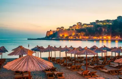 a group of chairs and umbrellas on a beach at Guest house, Small beach in Ulcinj