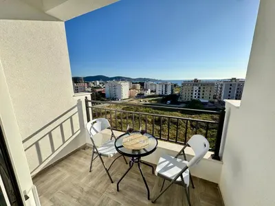 a balcony with a table and chairs and a view at Apartment LULU in Bar