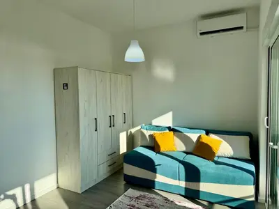 a bedroom with a blue and white bed and a cabinet at Apartment LULU in Bar