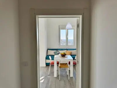 a dining room with a table and a couch at Apartment LULU in Bar