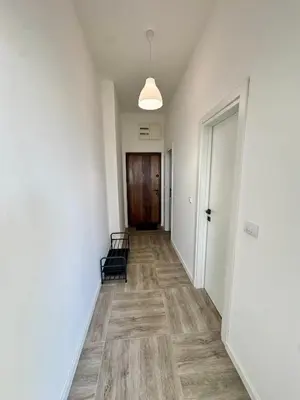an empty hallway with a door and a chair at Apartment LULU in Bar