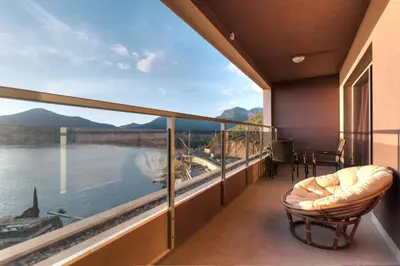 a balcony with a view of the water and mountains at Harmonia Sunrise Apartments in Budva