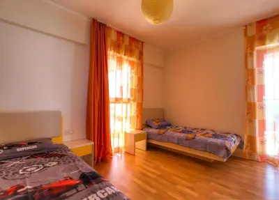 a bedroom with two beds and a window at Harmonia Sunrise Apartments in Budva