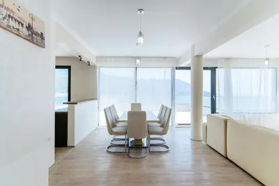 a dining room with a table and chairs at Harmonia Sunrise Apartments in Budva