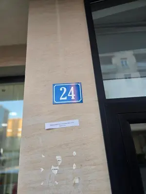 a blue sign on the side of a door at City kvart Delta apartment in Podgorica