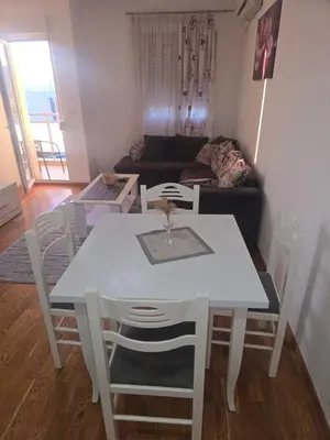 a white table and chairs in a living room at City kvart Delta apartment in Podgorica
