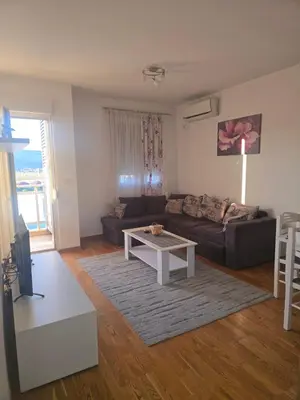 a living room with a couch and a coffee table at City kvart Delta apartment in Podgorica