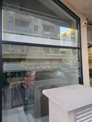 a reflection of a car in a window at City kvart Delta apartment in Podgorica
