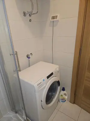 a small bathroom with a washing machine in it at City kvart Delta apartment in Podgorica