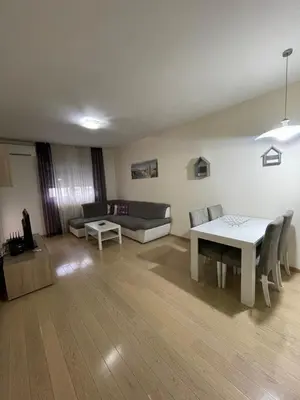 a living room with a table and a couch at City kvart apartman 35 eur in Podgorica