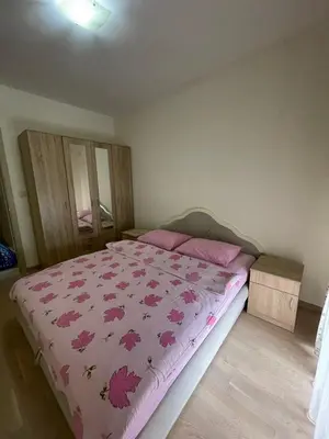 a bedroom with a bed with a pink blanket at City kvart apartman 35 eur in Podgorica