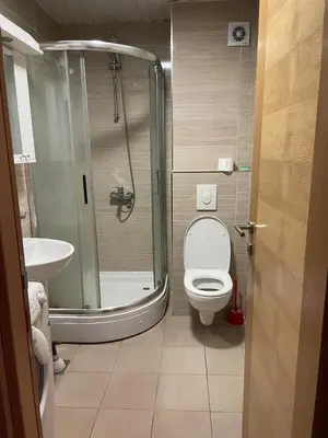 a bathroom with a shower and a toilet and a sink at City kvart apartman 35 eur in Podgorica