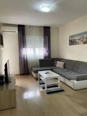 a living room with a couch and a coffee table at City kvart apartman 35 eur in Podgorica