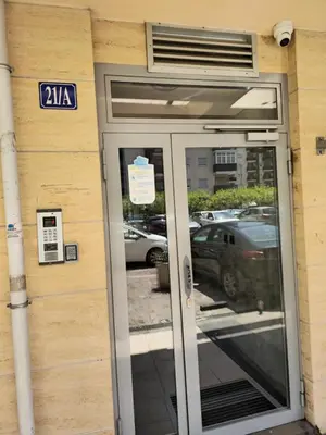 an entrance to a building with a revolving door at City kvart apartman 35 eur in Podgorica