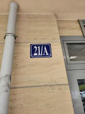a blue sign on the side of a building at City kvart apartman 35 eur in Podgorica