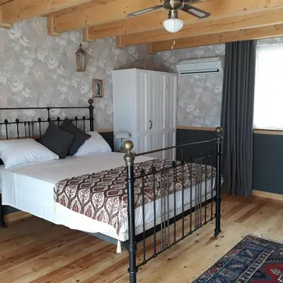 a bedroom with a bed and a ceiling fan at villa lavander hill in Budva