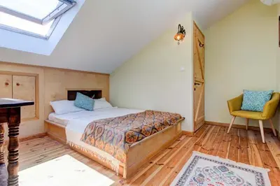 a bedroom with a bed and a table and a chair at villa lavander hill in Budva