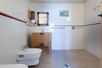 a bathroom with a white toilet and a sink at villa lavander hill in Budva