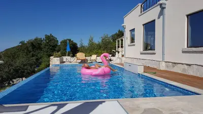 a couple in an inflatable pool in a house at villa lavander hill in Budva