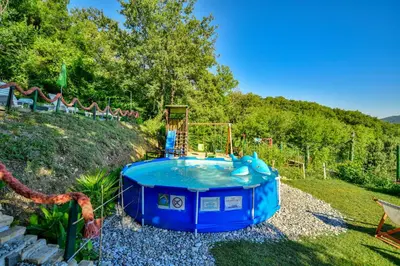 a blue hot tub in the middle of a yard at Pataki Guesthouse in Petrovac na Moru